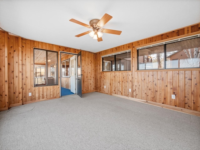 6451 Stardust Ln NE, Carlos Twp, MN 56308 - carpeted spare room featuring a ceiling fan, wooden walls, and baseboards