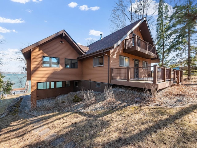 6451 Stardust Ln NE, Carlos Twp, MN 56308 - view of side of property with a balcony, a shingled roof, and a wooden deck