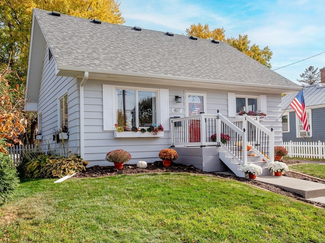 bungalow-style home with a front yard