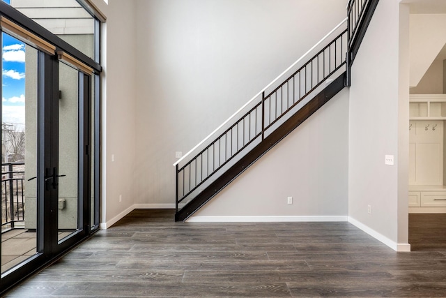 entrance foyer with dark wood-type flooring, french doors, and a high ceiling