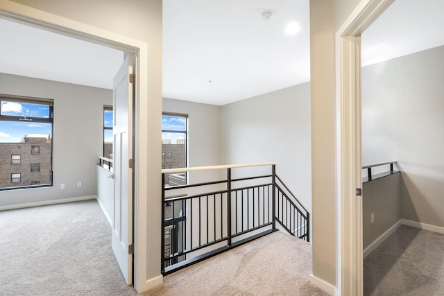 hallway featuring light carpet