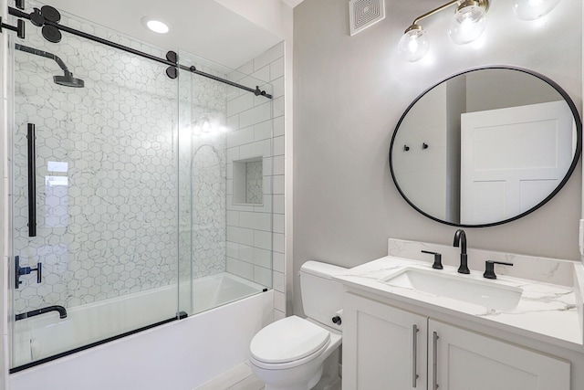 full bathroom with vanity, shower / bath combination with glass door, and toilet