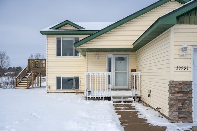 view of snow covered property entrance