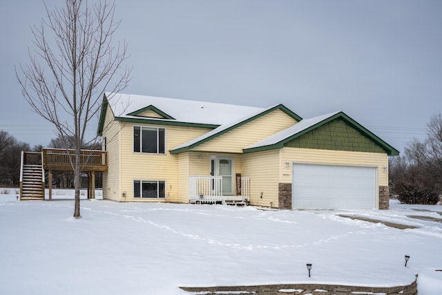 split level home featuring a garage and a deck