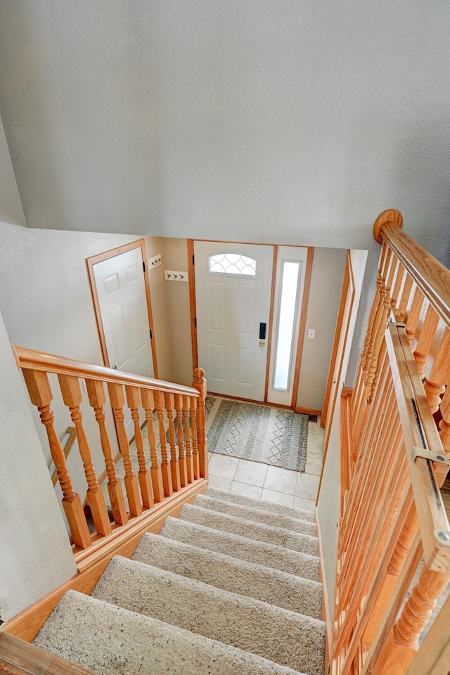 entrance foyer featuring light tile patterned floors and a textured ceiling