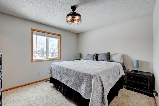 bedroom featuring carpet and a textured ceiling