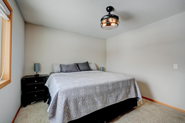 carpeted bedroom featuring a textured ceiling