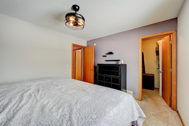 bedroom featuring baseboards, carpet floors, and a textured ceiling