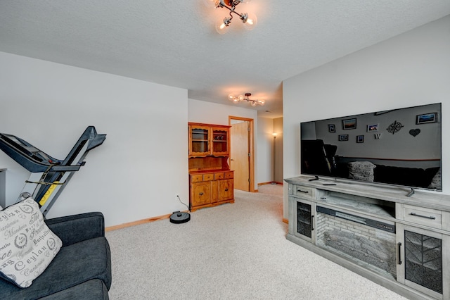 living area with light carpet, baseboards, and a textured ceiling