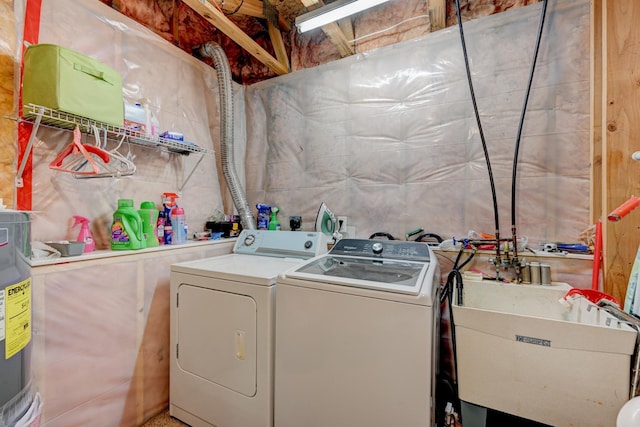 laundry room with washer and dryer, laundry area, and a sink