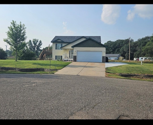 view of front of house with a garage and a front lawn