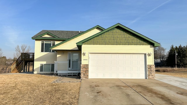 view of front of house with stairs, concrete driveway, and a garage