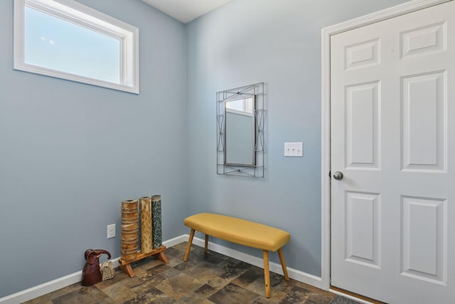 interior space with stone finish flooring and baseboards