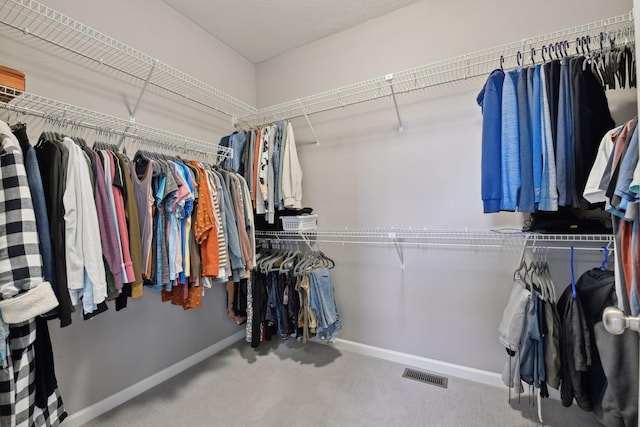 spacious closet with carpet floors and visible vents