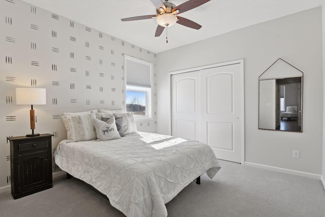 carpeted bedroom featuring ceiling fan, a closet, and baseboards