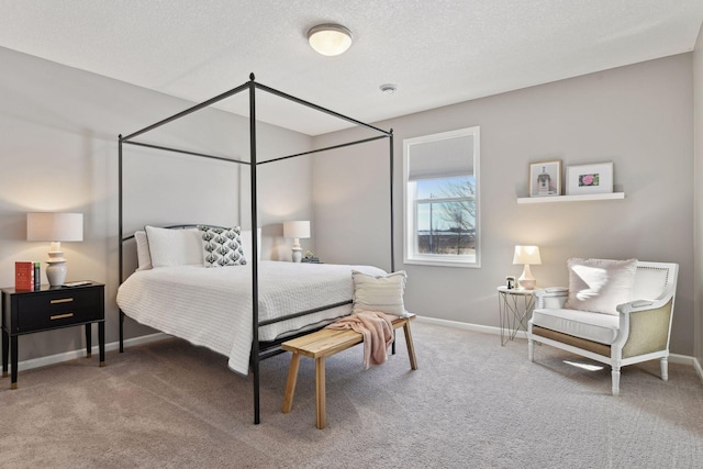 bedroom with carpet, baseboards, and a textured ceiling