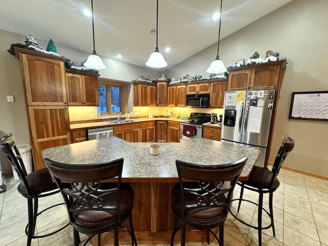 kitchen with stainless steel appliances, a center island, hanging light fixtures, and sink