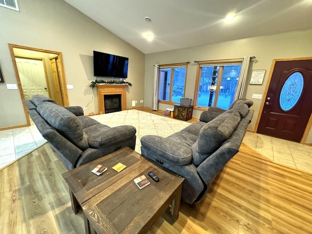 living room with vaulted ceiling and light wood-type flooring