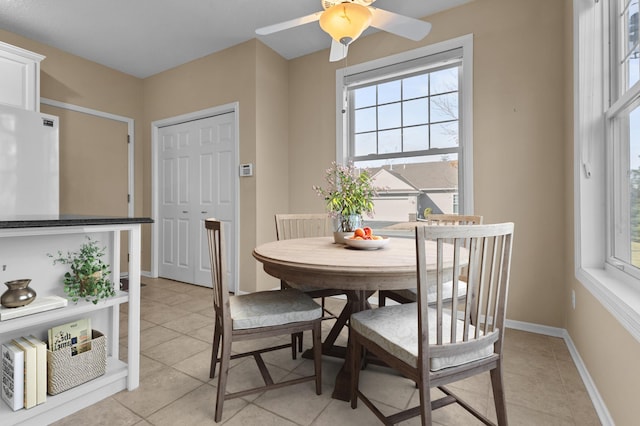 dining space featuring baseboards and light tile patterned floors