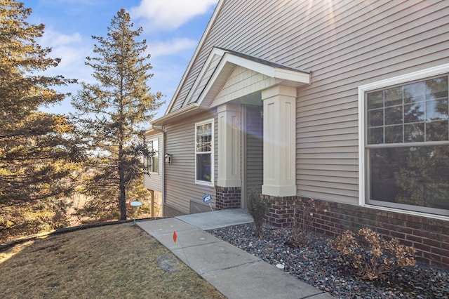 view of exterior entry with brick siding