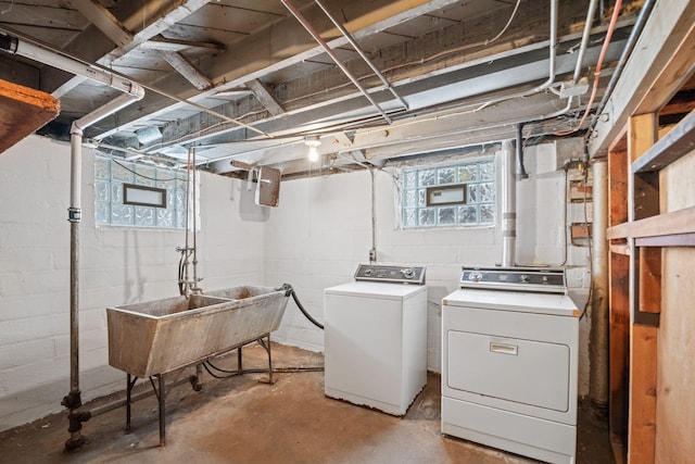 clothes washing area featuring sink and independent washer and dryer