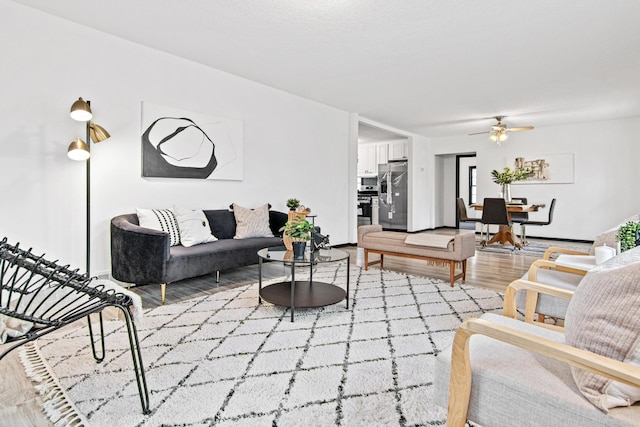 living room featuring ceiling fan and wood-type flooring