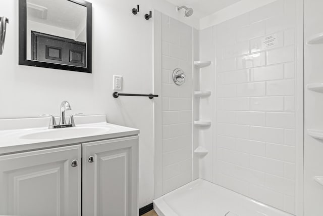 bathroom featuring vanity and a tile shower