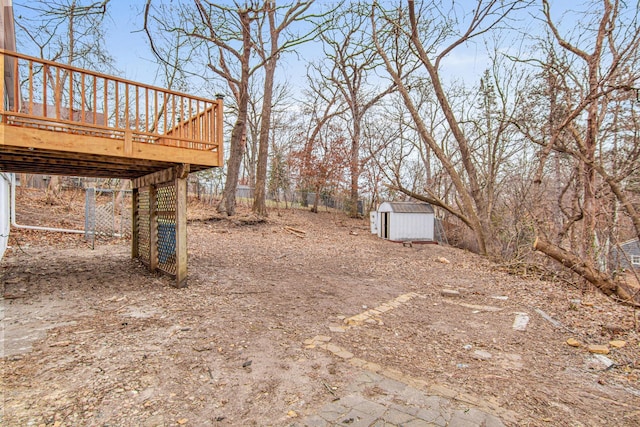 view of yard with a deck and a storage unit