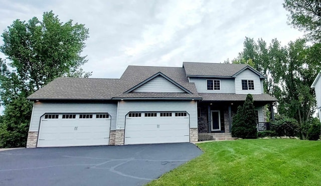 view of front of home featuring a garage and a front lawn