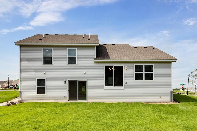 back of house with a lawn