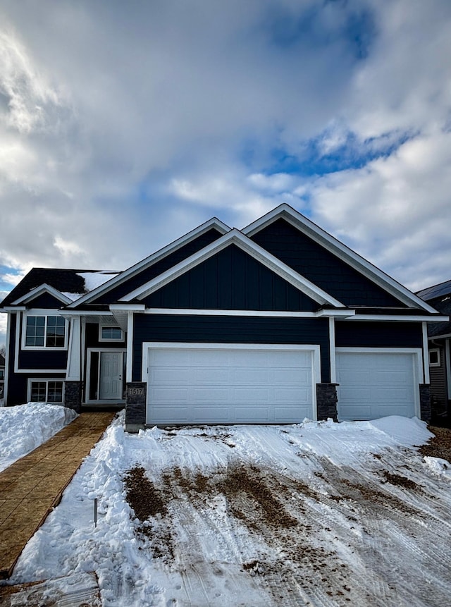 craftsman inspired home with board and batten siding and an attached garage