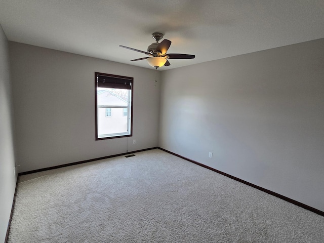 carpeted empty room with ceiling fan