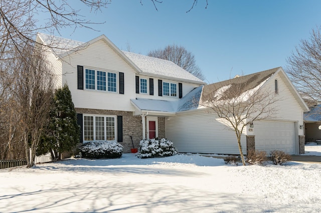 traditional-style house featuring a garage and brick siding