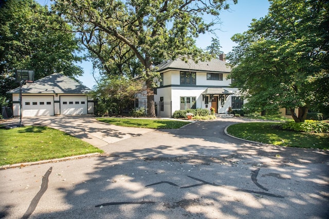 view of front of house with a garage and a front yard