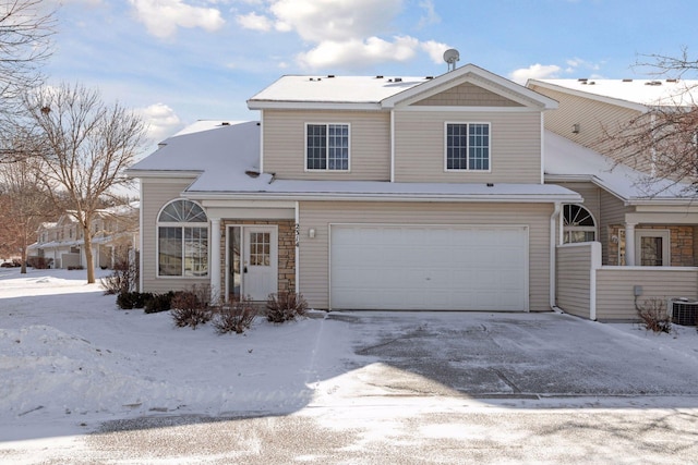 view of front property with cooling unit and a garage