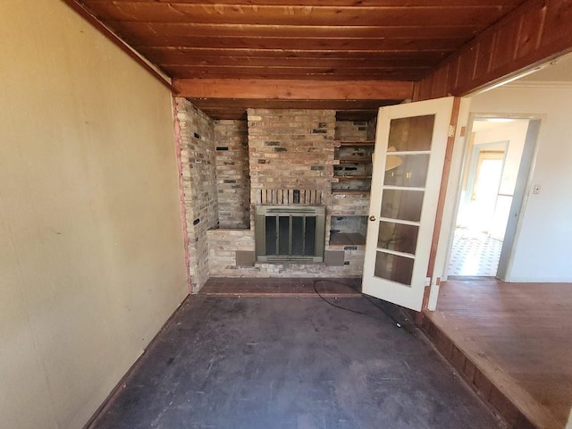 unfurnished living room featuring wood ceiling and a fireplace