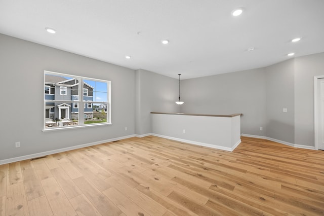 unfurnished living room featuring light hardwood / wood-style floors