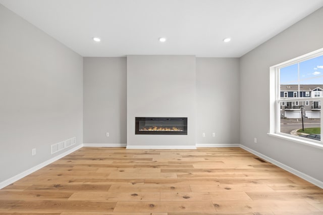 unfurnished living room with light hardwood / wood-style flooring