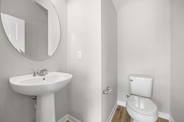 bathroom with sink, wood-type flooring, and toilet