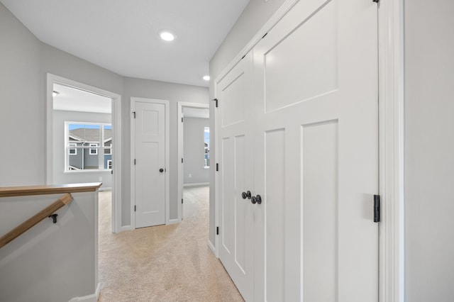 hallway with light colored carpet