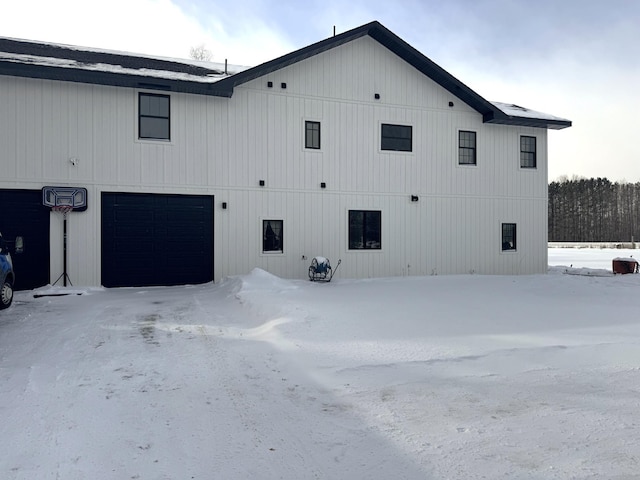 view of snow covered exterior featuring a garage