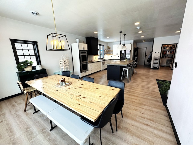 dining area featuring a healthy amount of sunlight and light hardwood / wood-style flooring