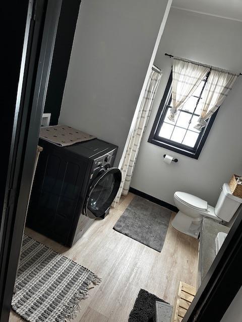 bathroom with hardwood / wood-style flooring and toilet