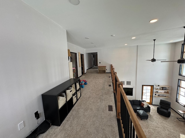 hallway featuring light colored carpet