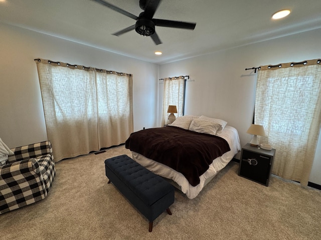 bedroom featuring light colored carpet and ceiling fan