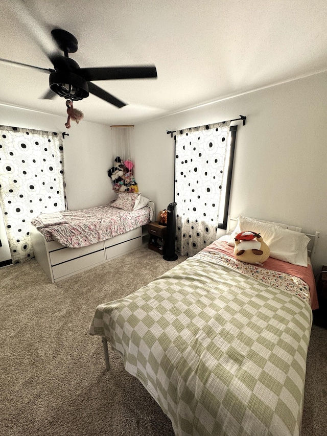 bedroom featuring carpet, a textured ceiling, and ceiling fan