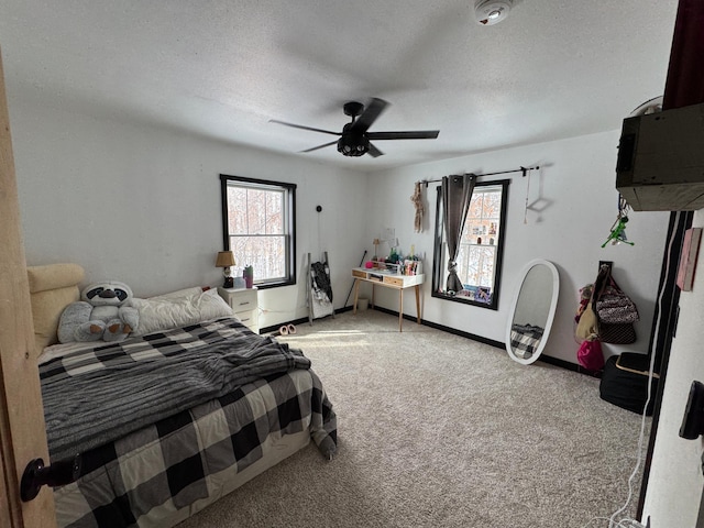 bedroom featuring light carpet, ceiling fan, and a textured ceiling