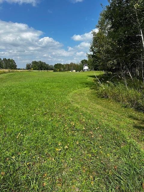 view of yard with a rural view