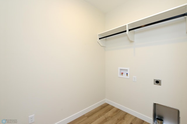 washroom with baseboards, light wood-style floors, washer hookup, electric dryer hookup, and laundry area