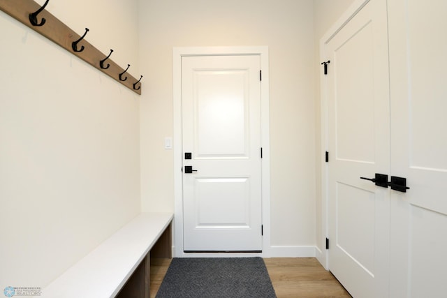 mudroom with baseboards and light wood-style flooring